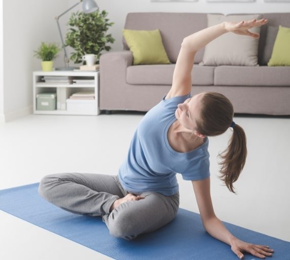 Woman Practicing Yoga At Home